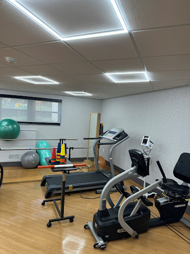 A well-equipped gym space featuring various exercise machines and fitness tools.