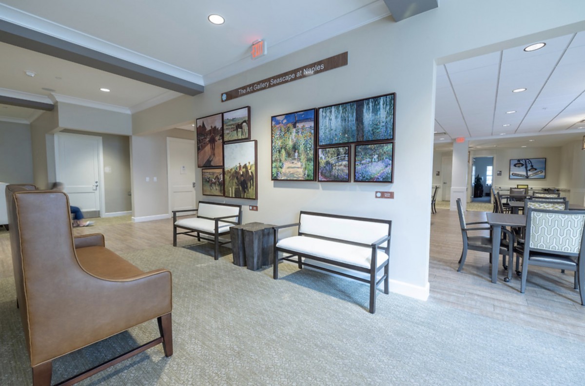 A modern lobby with comfortable seating and decorative artwork on the walls.