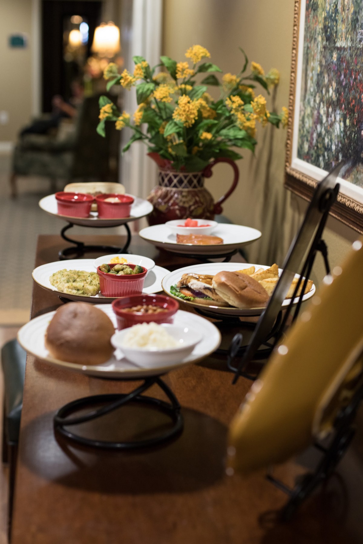 A dining table set with various plates of food, including bread and side dishes, ready for a meal.