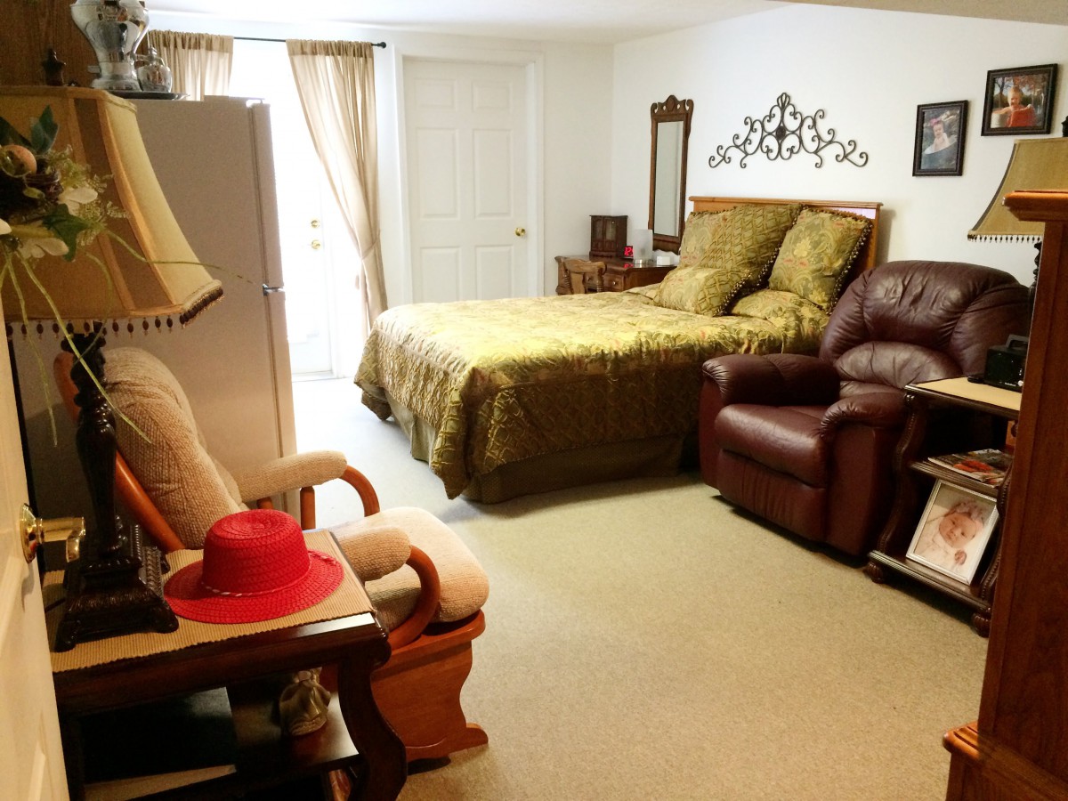 A cozy bedroom with a comfortable bed and seating area.