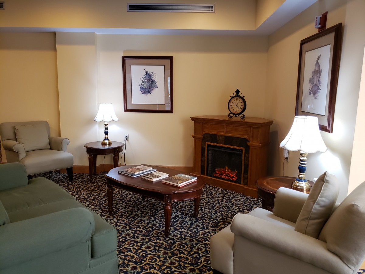 A cozy living room with elegant furniture and a warm fireplace.