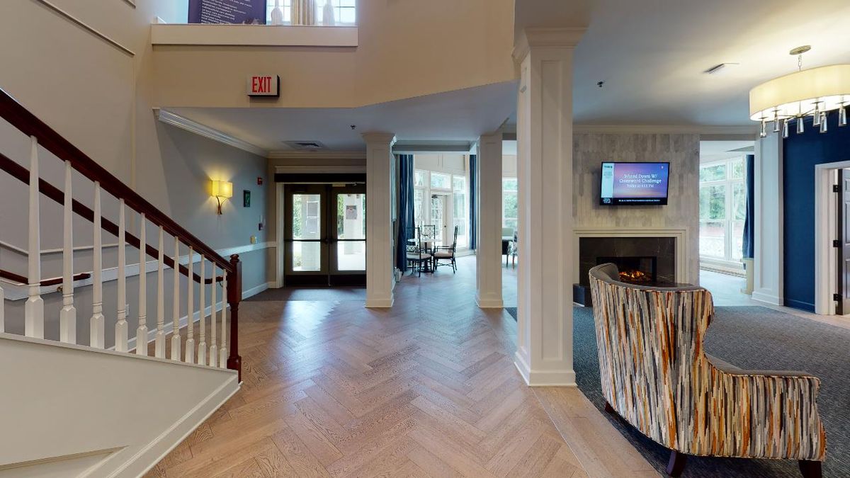 A modern lobby area with herringbone flooring and elegant decor.