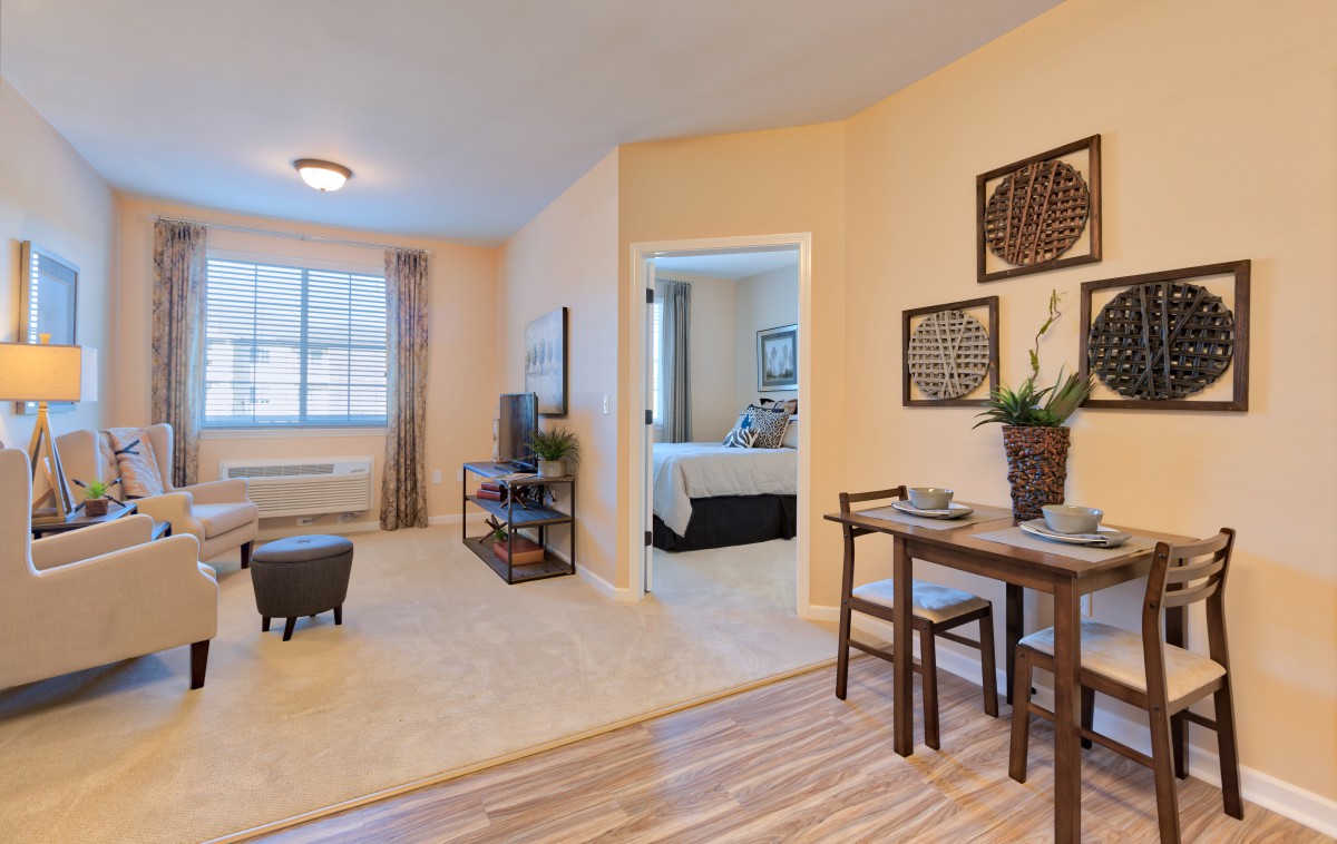 A cozy apartment interior featuring a living room and dining area with modern decor.