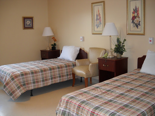 A cozy bedroom with twin beds and warm decor.