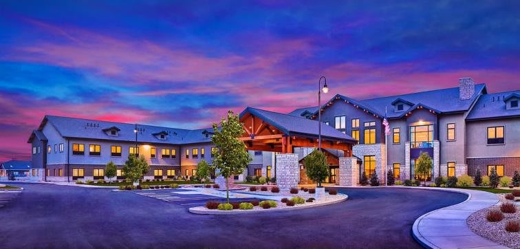 A modern hotel building at sunset with a welcoming entrance.