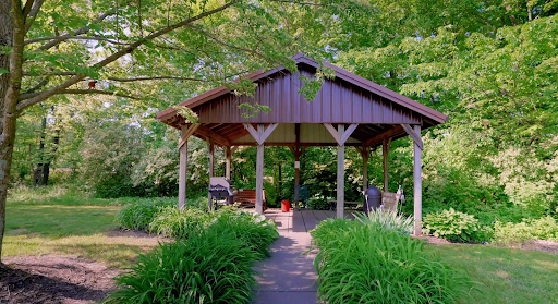 A serene gazebo surrounded by lush greenery, perfect for a peaceful retreat.