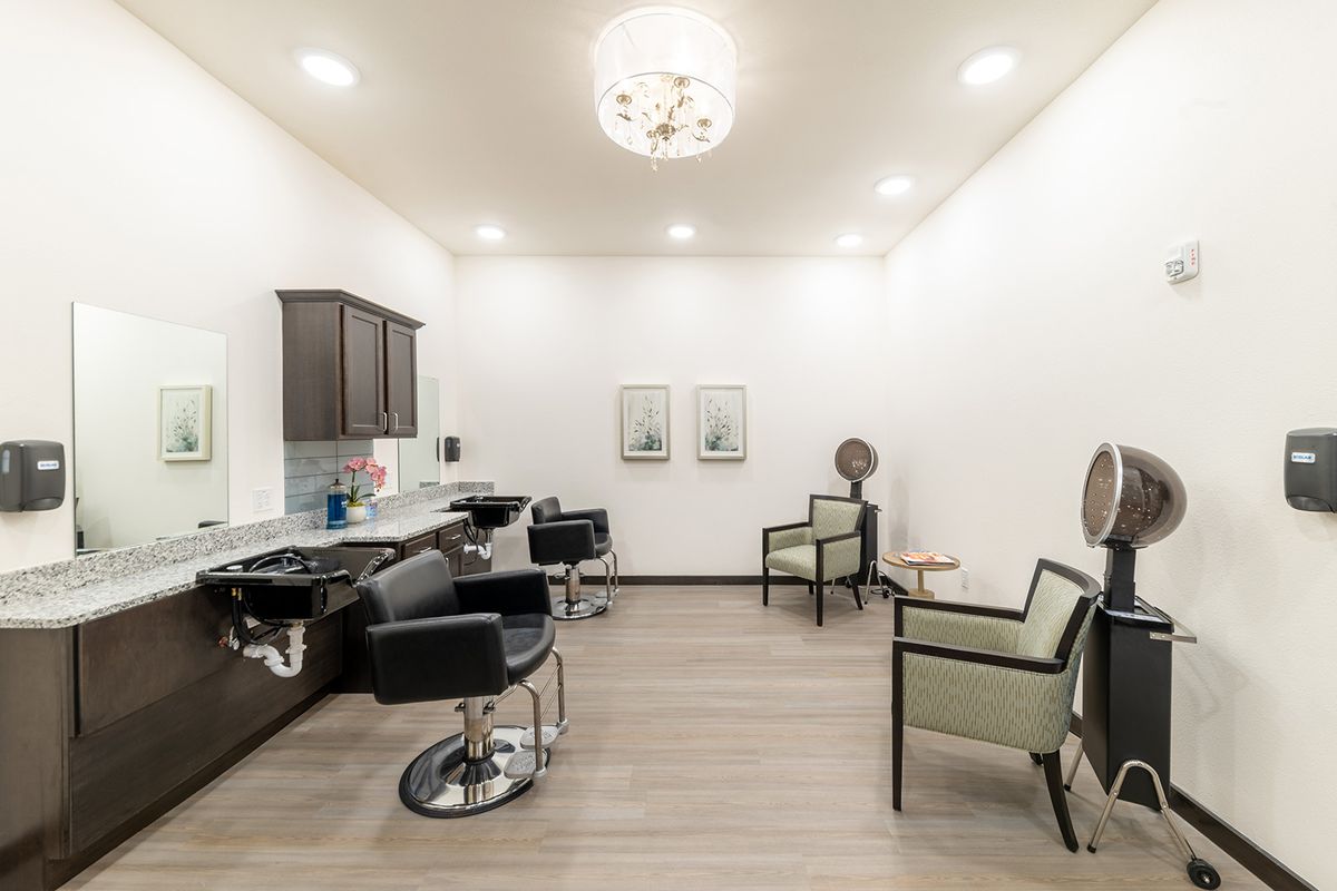 A modern and stylish hair salon interior with comfortable chairs and well-lit space.