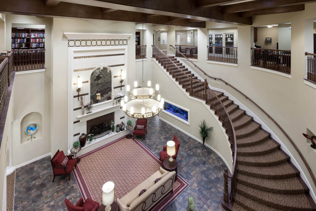 A luxurious lobby with a grand staircase and elegant chandelier.