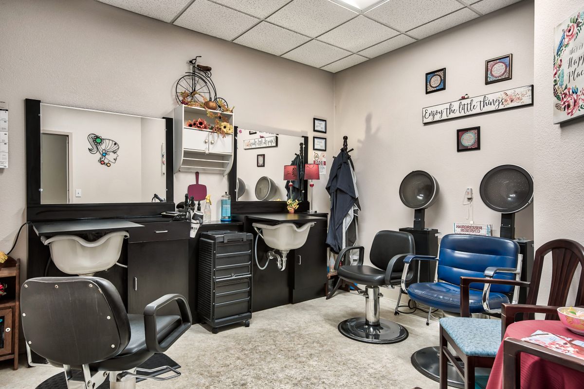 A well-equipped hair salon with chairs, mirrors, and styling tools ready for clients.