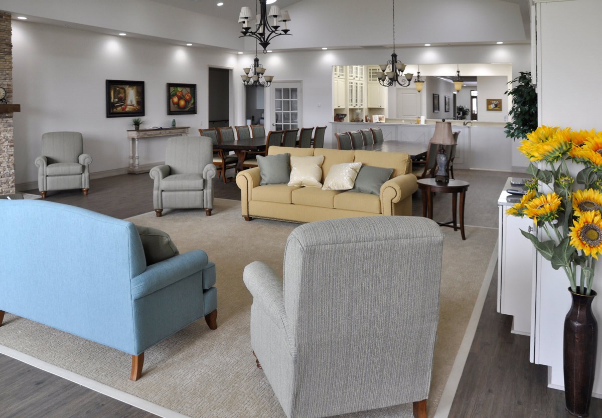 A modern living room with comfortable sofas and chairs arranged in an open, well-lit space.