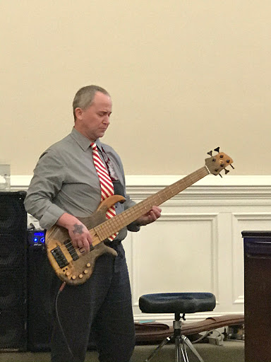 A musician performing on a bass guitar.