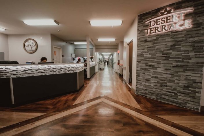 A modern hospital reception area with a sleek design and warm lighting.