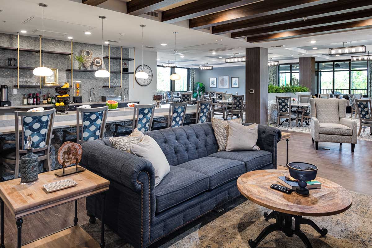 A modern lounge area with a stylish couch and coffee table in an open space setting.