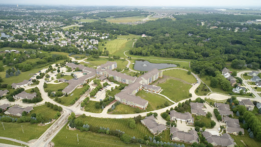 Aerial view of a suburban area featuring green spaces and developed buildings.