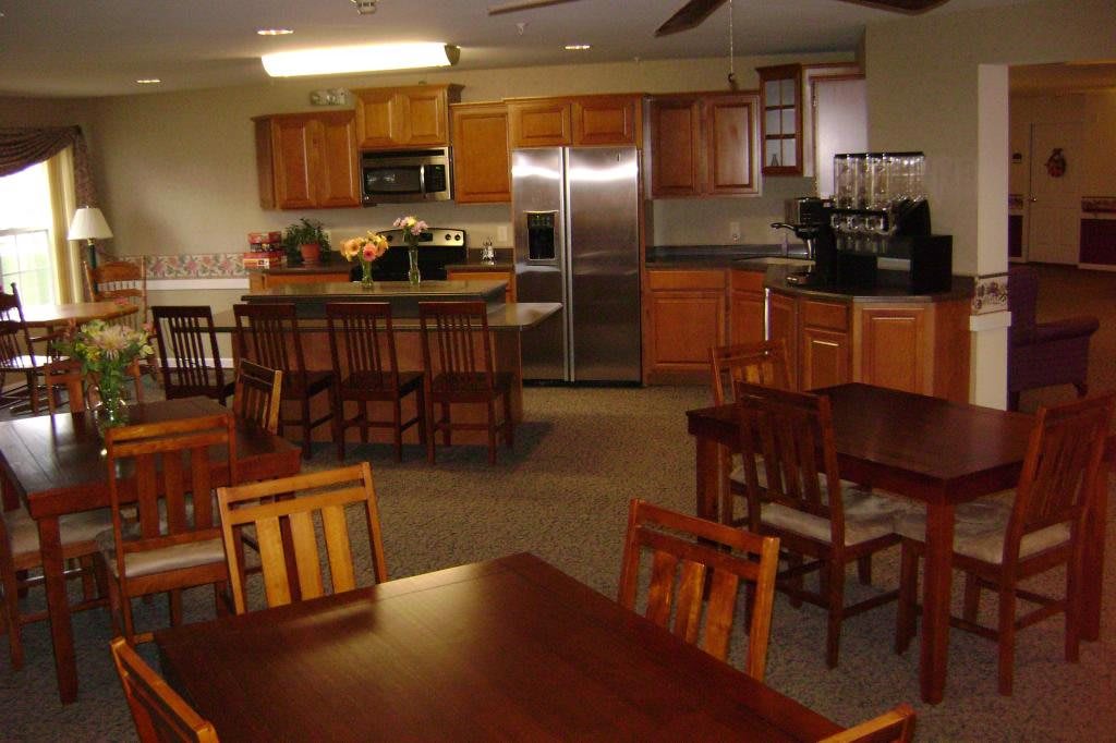 A cozy kitchen and dining area with wooden furniture and modern appliances.