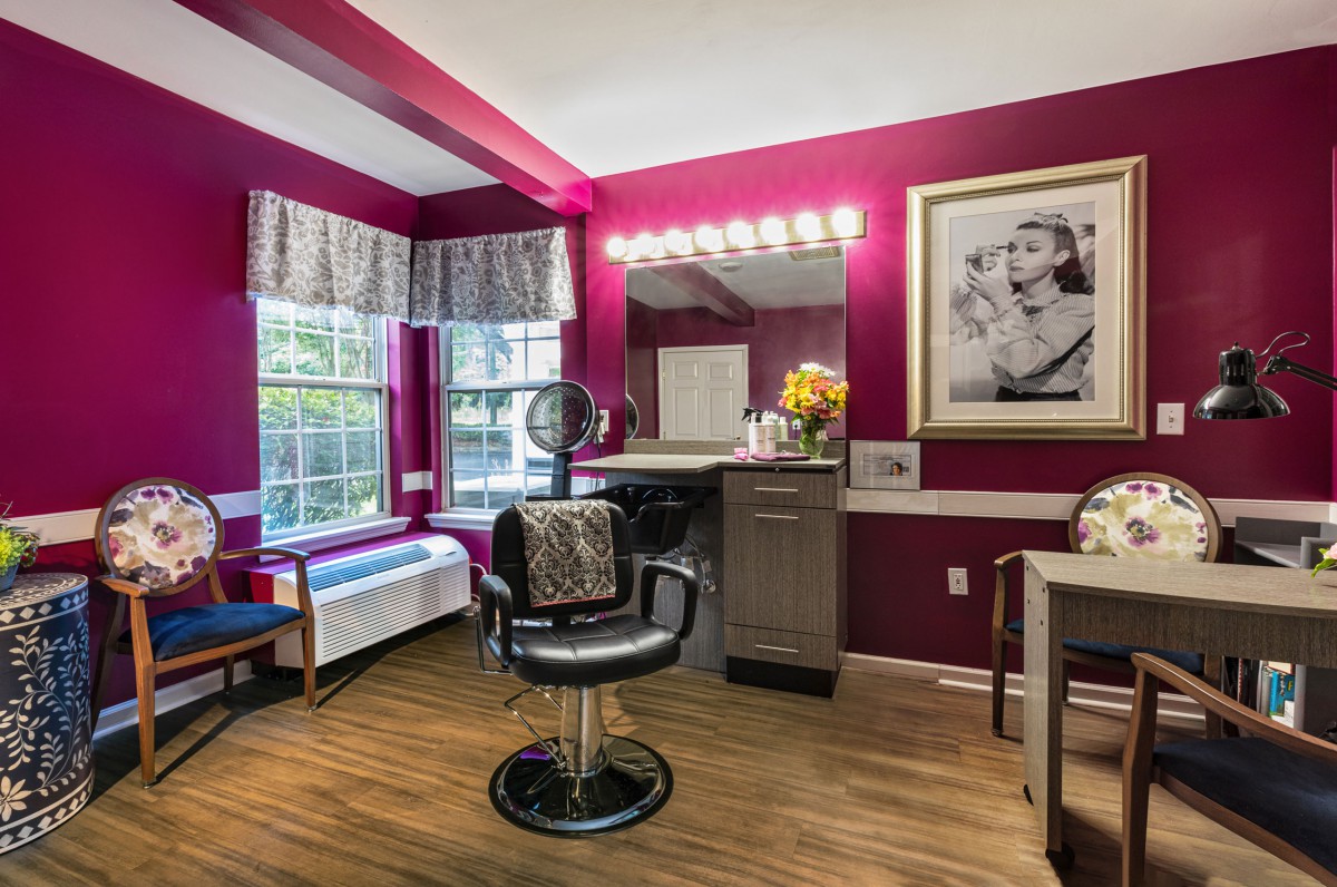 A cozy hair salon with stylish decor and bright lighting.