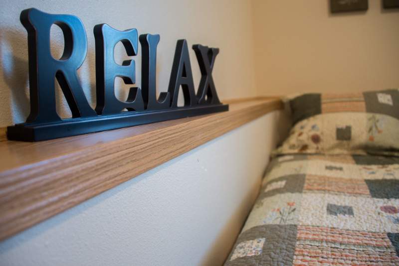 A cozy interior with a decorative 'RELAX' sign on a wooden shelf.