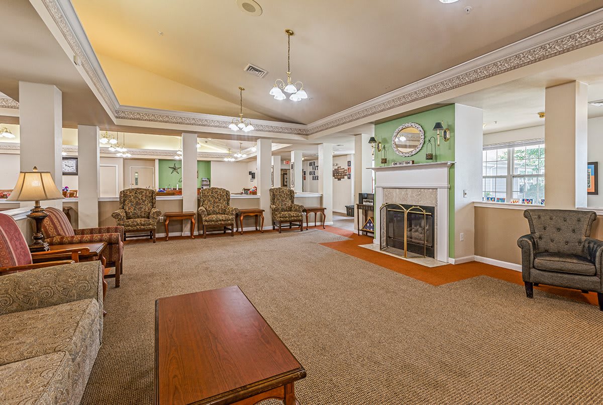 A spacious living room with a fireplace, comfortable seating, and soft lighting.