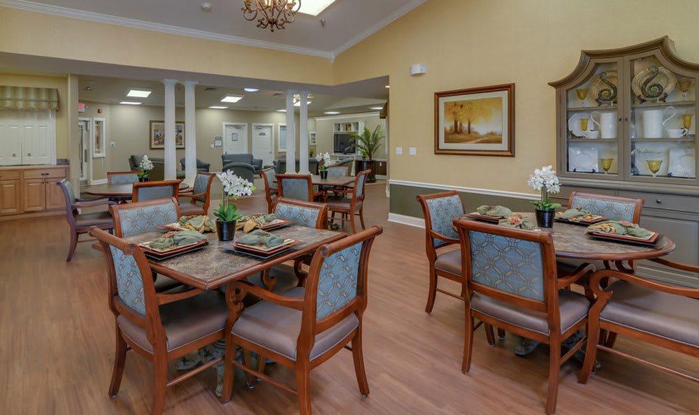 A well-decorated dining area with neatly arranged tables and chairs.