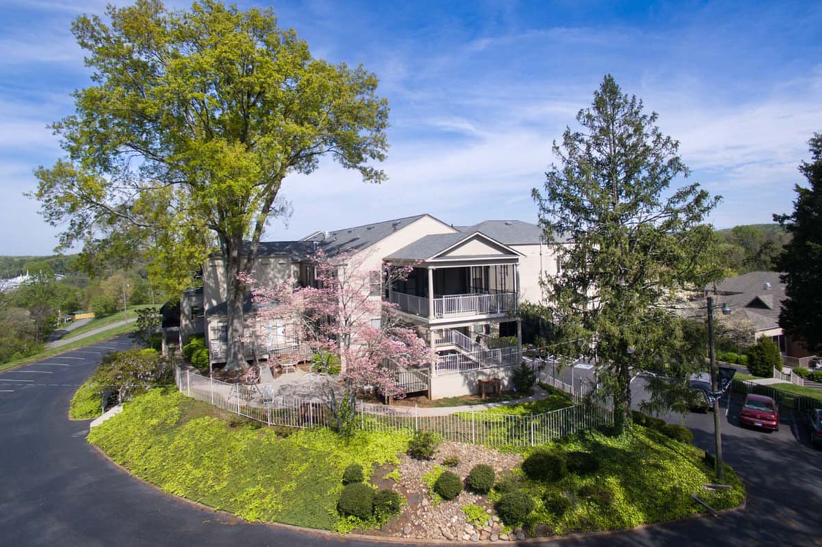 A beautiful residential home surrounded by lush greenery and a well-maintained garden.