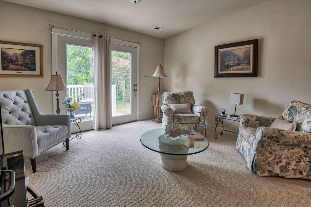 Cozy living room with comfortable seating and a glass coffee table.