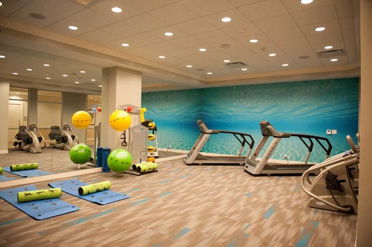 A modern gym with exercise equipment, including treadmills and fitness balls.