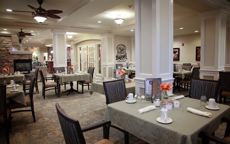 An elegant dining room setting with neatly arranged tables and chairs.