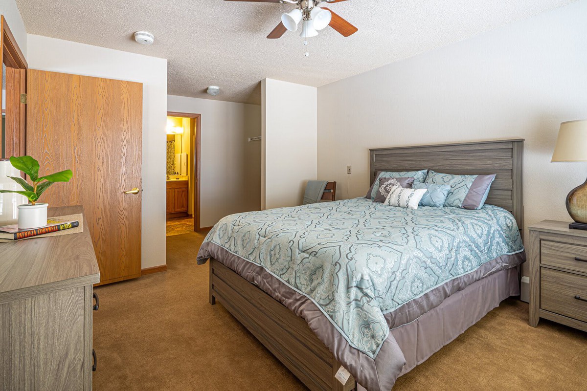 A cozy bedroom with a large bed and modern decor.