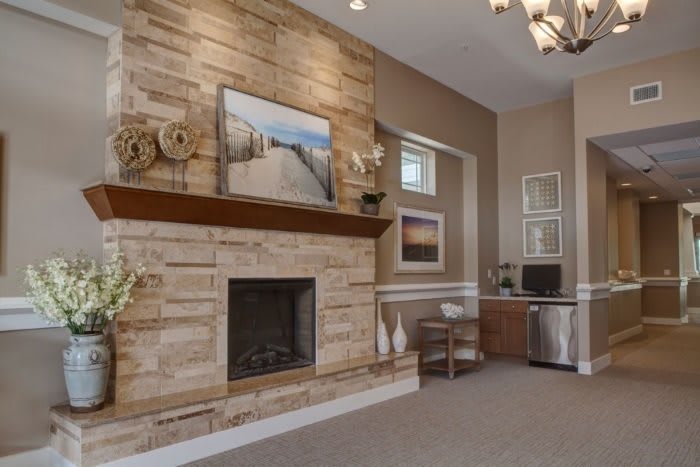 A cozy living room with a stone fireplace and modern decor.