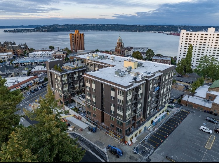 Aerial view of urban buildings near a waterfront.