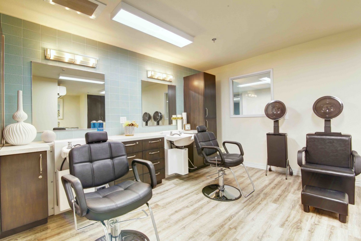 A modern hair salon with chairs and mirrors set against a stylish interior.