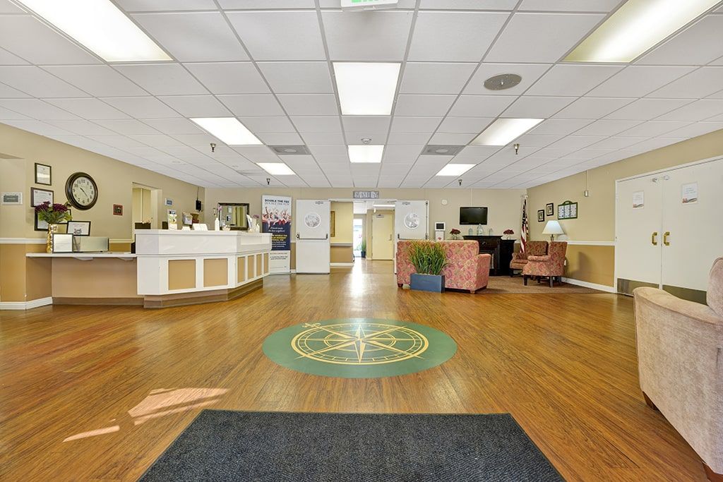 A spacious and well-lit reception area with seating and a front desk.