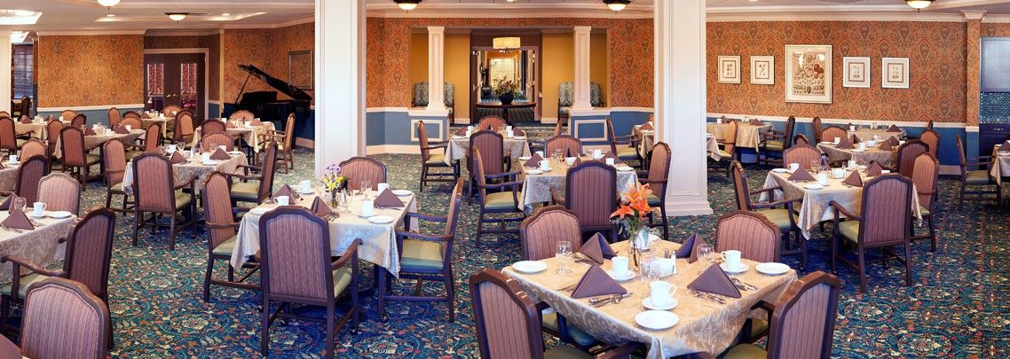 A beautifully decorated dining room with tables set for guests.