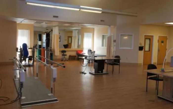 Rehabilitation room equipped for physical therapy exercises.