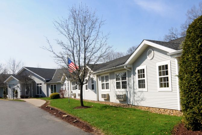 A suburban residential building with an American flag displayed outside.