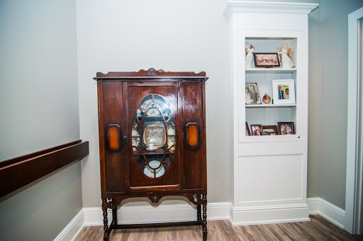 A beautifully crafted vintage cabinet with intricate details and glass accents, showcasing a blend of elegance and nostalgia in an interior setting.