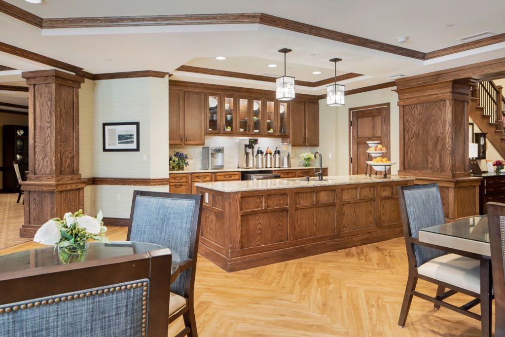 A modern kitchen with wooden cabinets, an island, and pendant lighting.