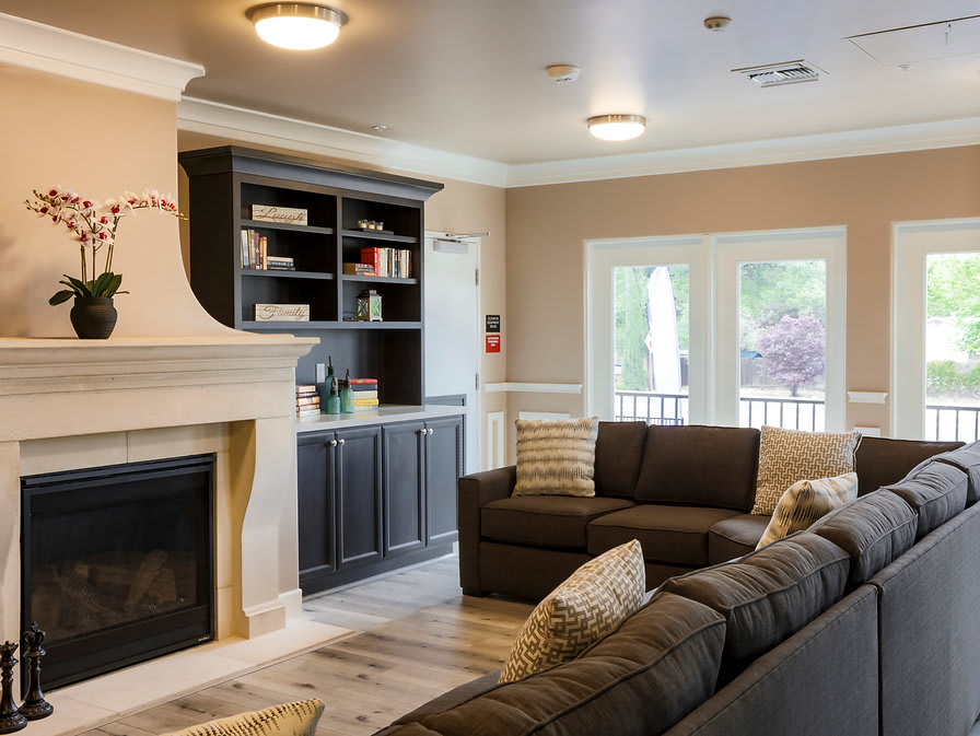 A cozy living room featuring a fireplace, modern decor, and comfortable sofas.