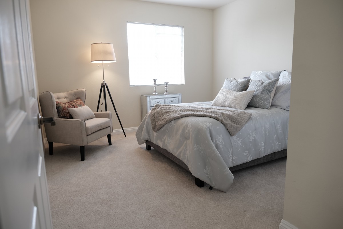A minimalist bedroom featuring a cozy bed, neutral colors, and stylish decor.