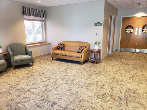 A cozy waiting area featuring comfortable seating and neutral tones.