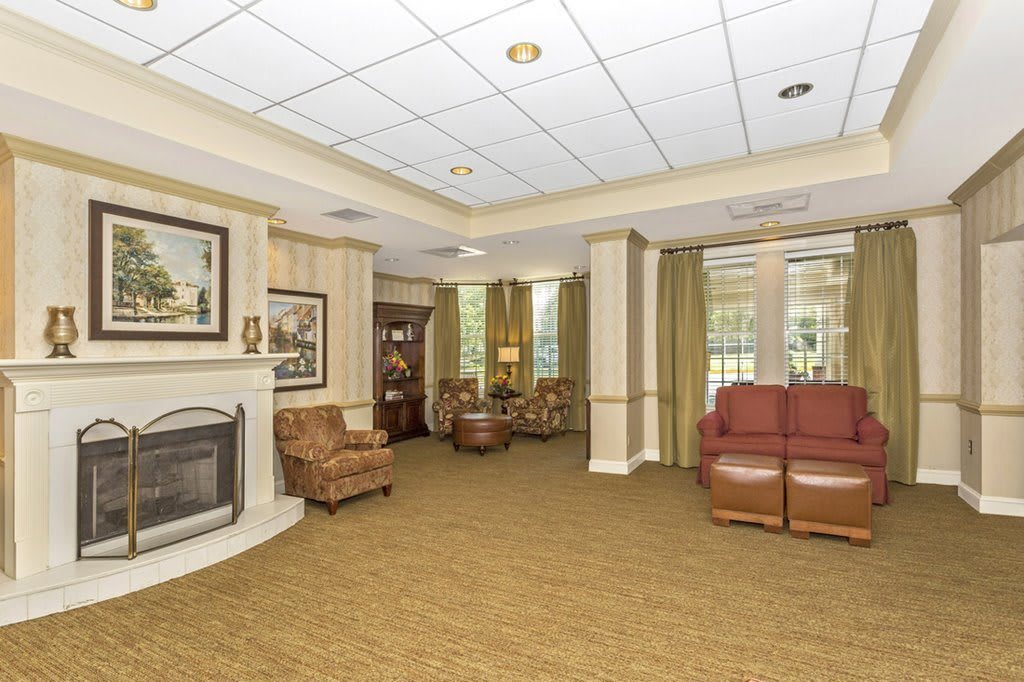 A cozy lounge area with comfortable seating and a fireplace.