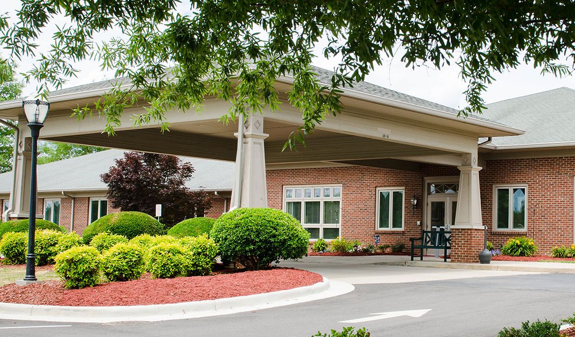 A welcoming building entrance surrounded by well-maintained landscaping.