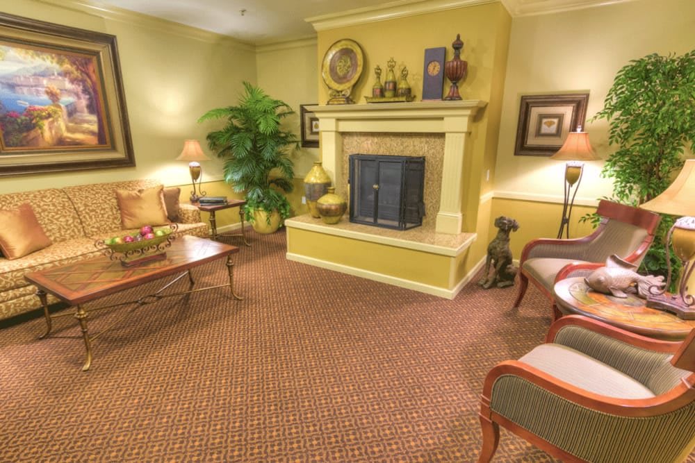 A cozy living room with a traditional fireplace and comfortable seating.