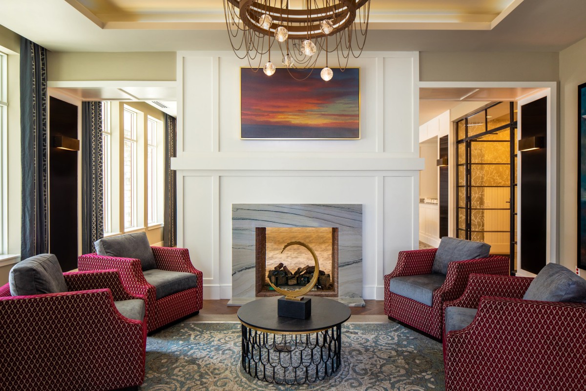 A modern living room featuring a fireplace, artwork, and comfortable seating.