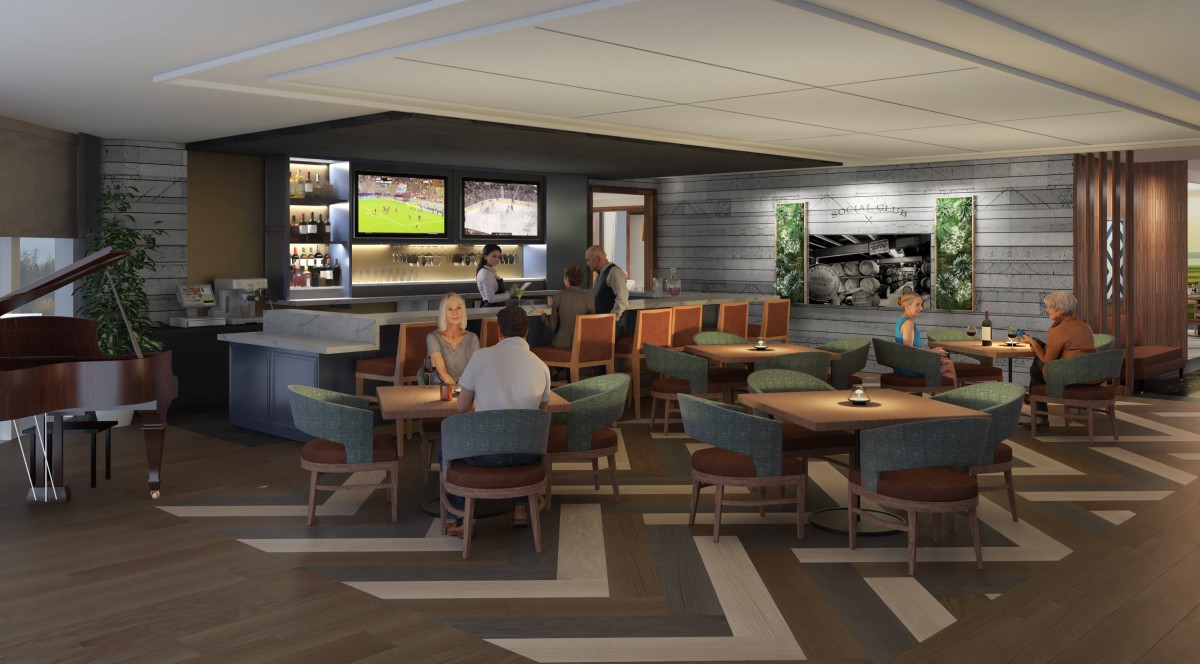 A modern bar and restaurant interior with patrons seated at tables, watching sports on television.