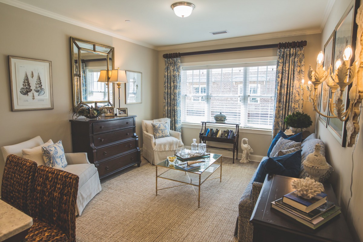 A cozy and elegantly decorated living room with ample natural light.