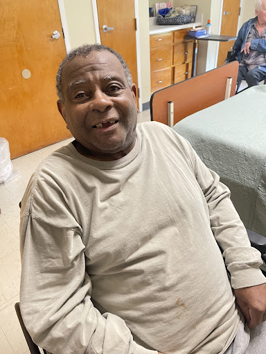 A joyful senior man enjoying his time in a care facility.