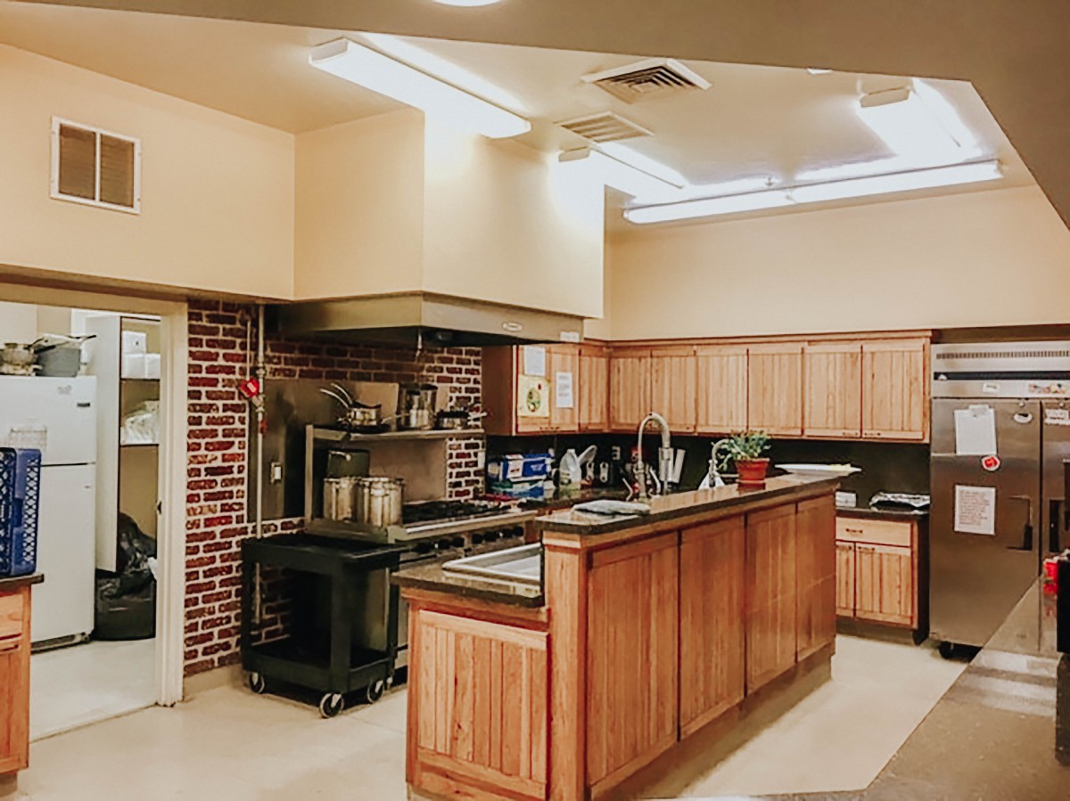 A modern kitchen interior featuring wooden cabinets and an island counter.