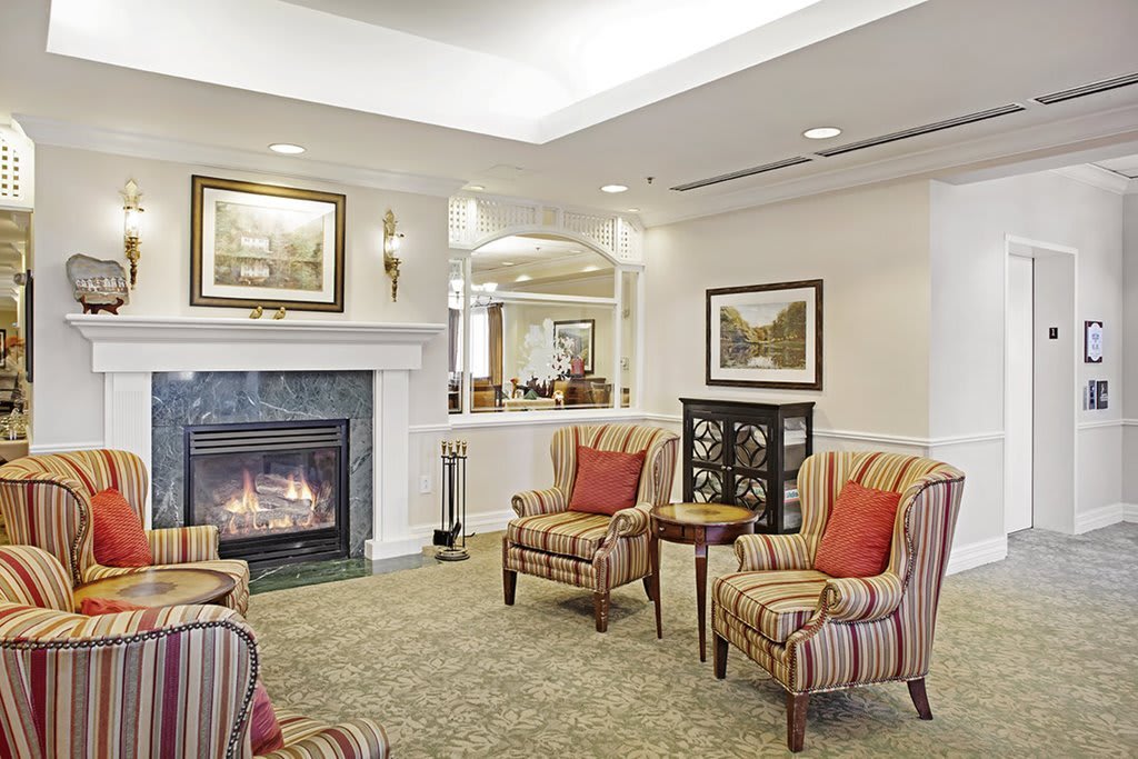 A cozy living room with a fireplace and comfortable armchairs.