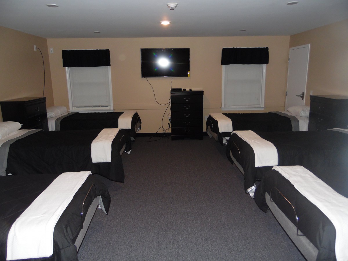 A wellness center therapy room with multiple massage tables arranged neatly.